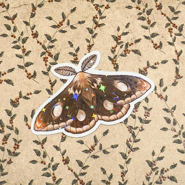 Sticker of a Waxing Gibbous moth on a brown paper made by atelier persephone