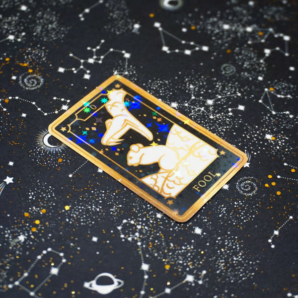 die cut stickers of the fool tarot card on a starry background