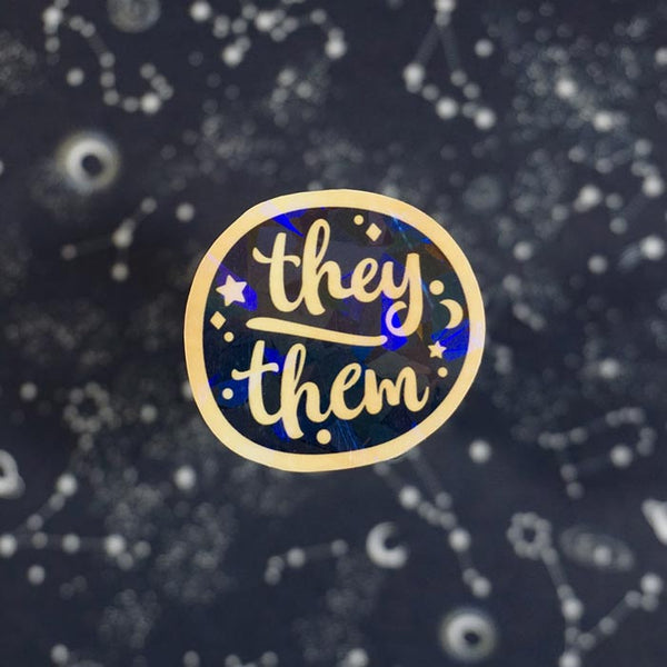 gold sticker of the lgbt pronoun they them created by atelier persephone