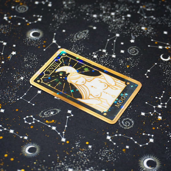 holo sticker representing the moon tarot card with a stars background