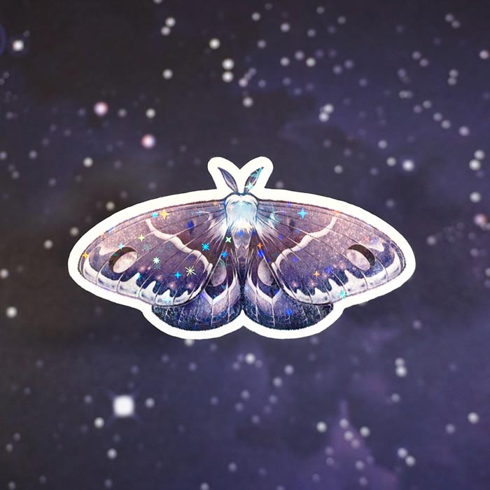 holographic sticker of a moth representing the waning gibbous moon on a starry paper from atelier persephone