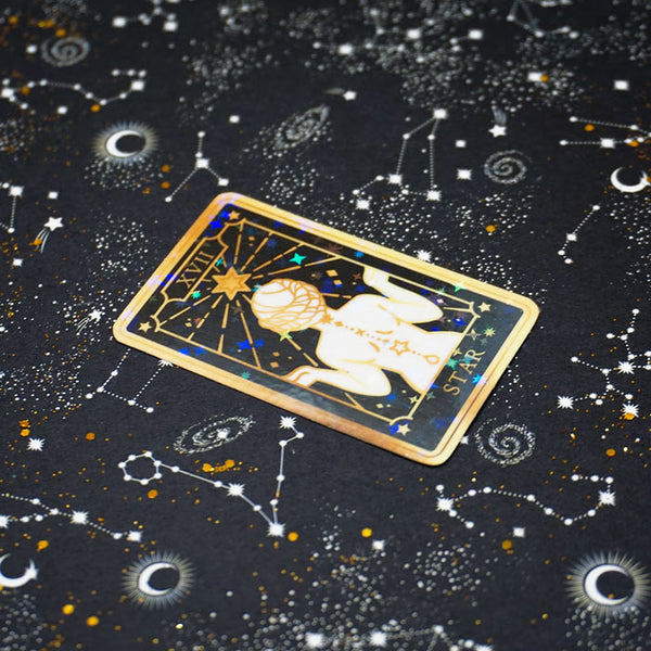 vinyl sticker of the star tarot card on a starry background